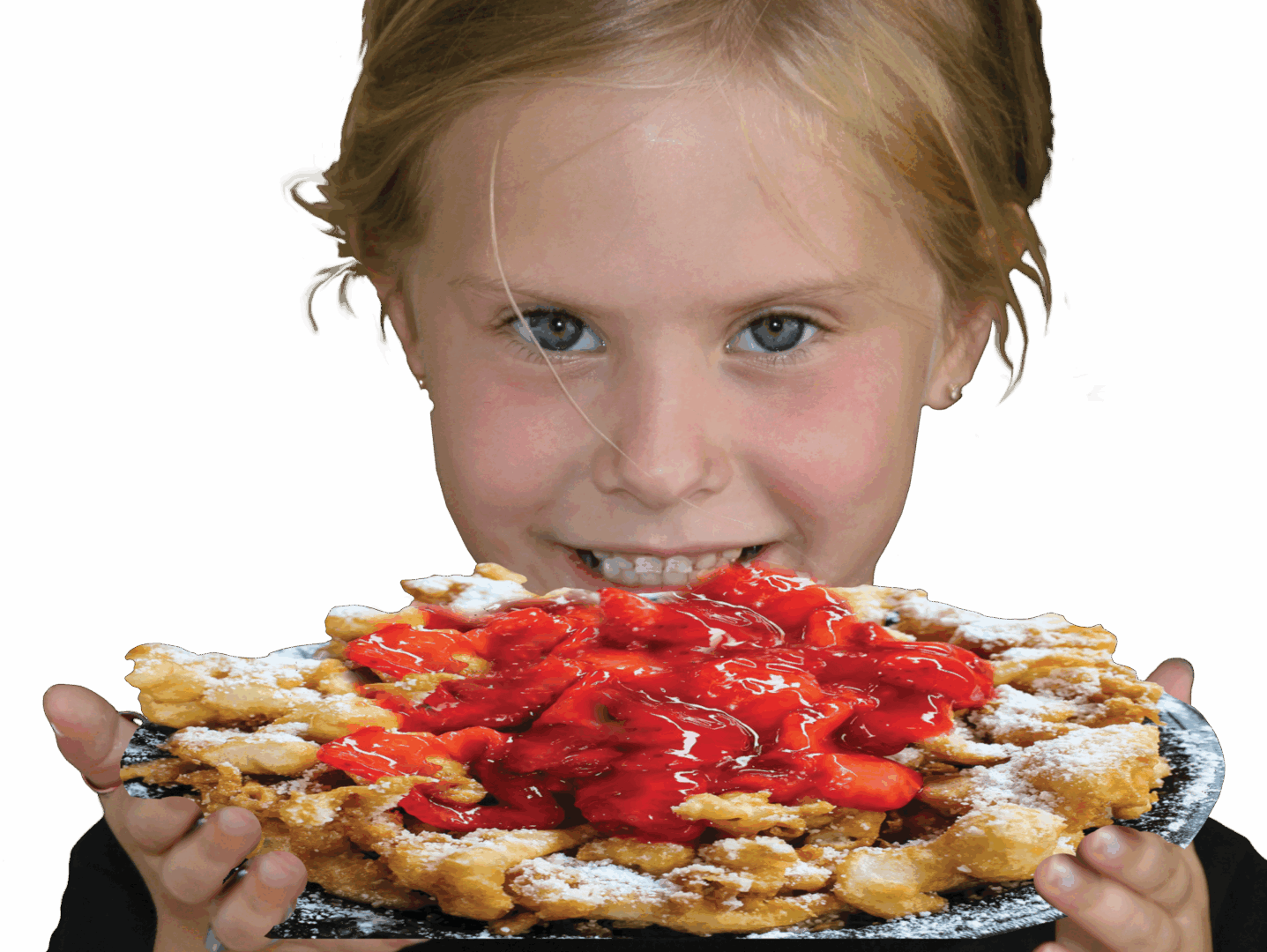 A girl excitedly looks at a waffle topped with strawberries and powdered sugar.