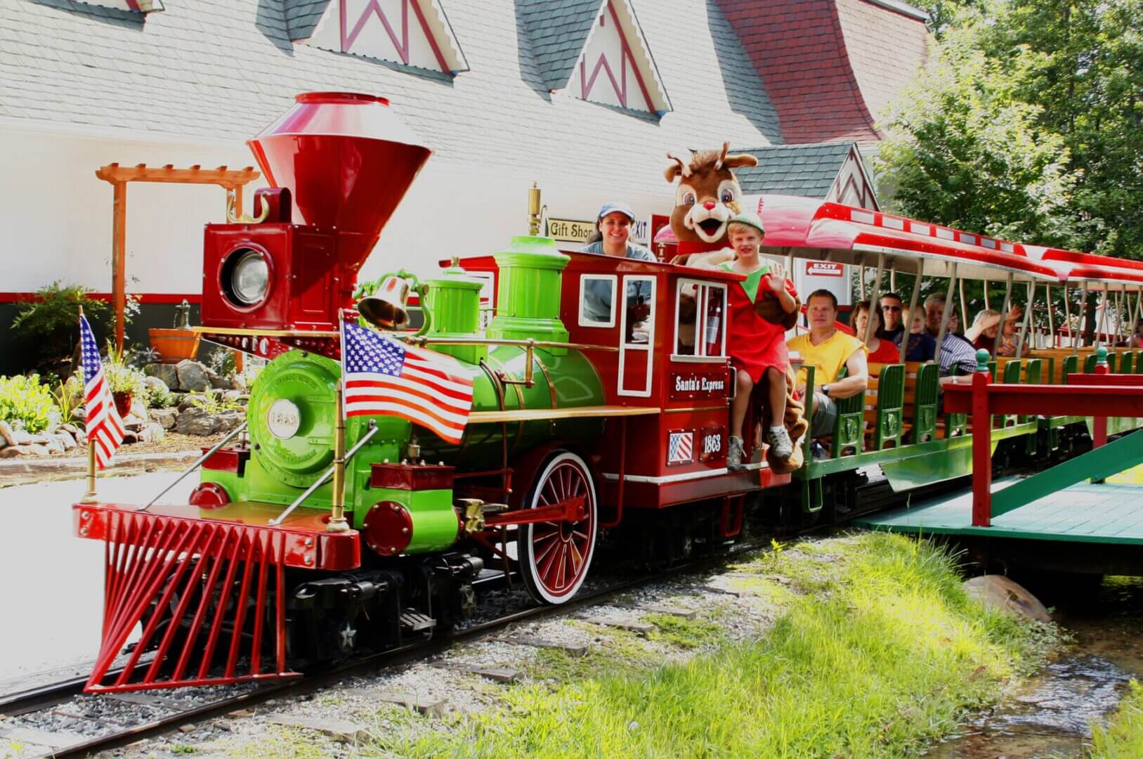 Open air passenger train with waving riders