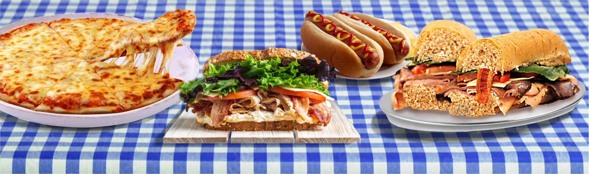 Pizza, sandwiches, and hot dogs on picnic table